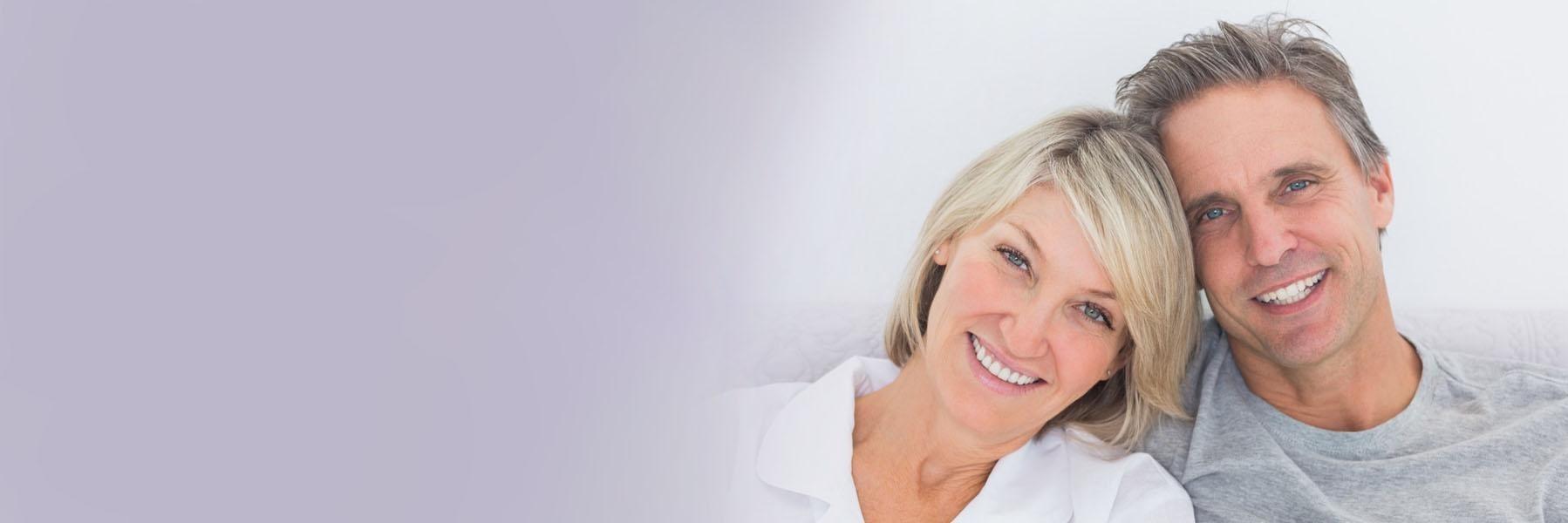 Older couple smiling heads together l Cosmetic dentist Temple TX