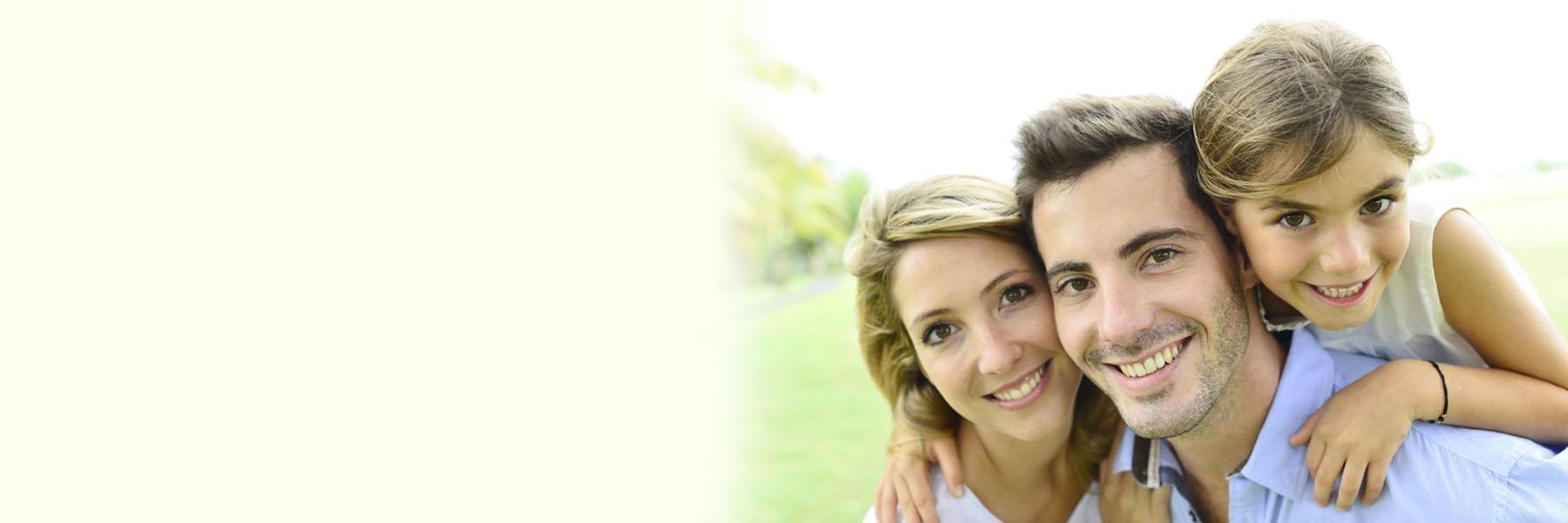 Family of three smiling & hugging l Children's dentist Temple TX