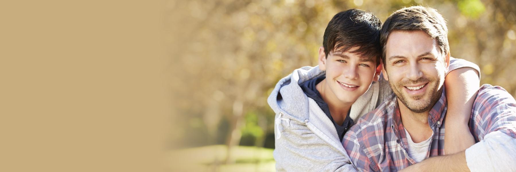 Father & son smiling outside l Dentist Temple TX
